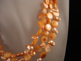 Muscheln und Perlen lang orange
